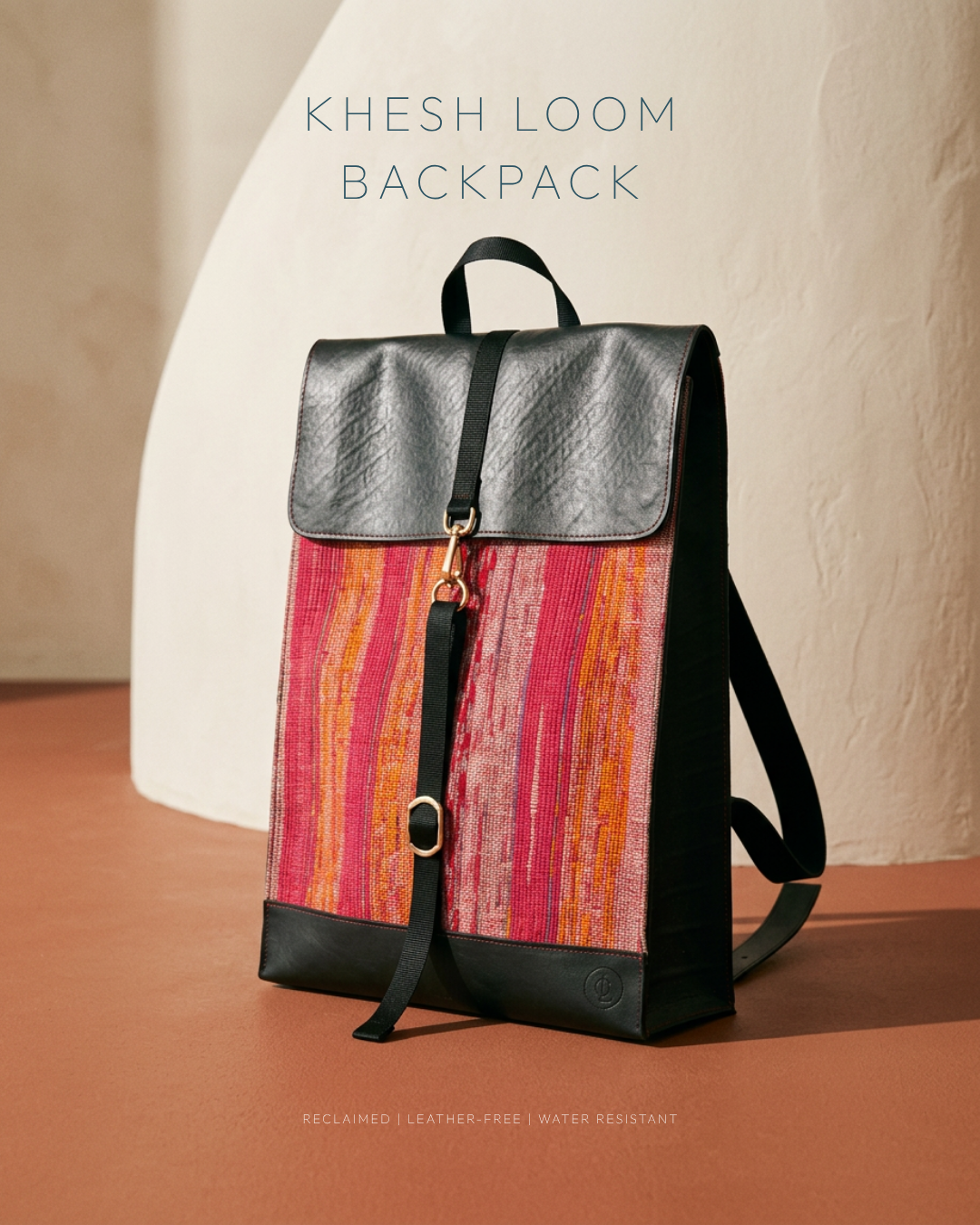 Handwoven Khesh backpack in warm striped Khesh textile, shown on a terracotta floor against a beige wall
