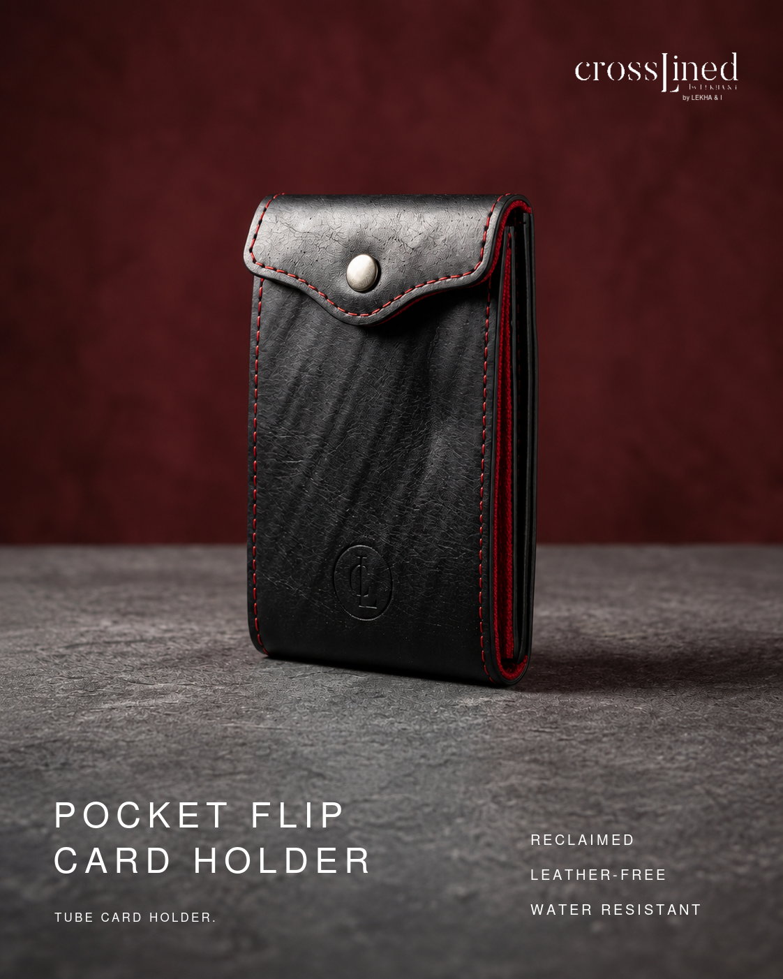 A black tyre tube pocket flip card holder wallet with red stitching and a silver snap button, standing upright on a gray surface against a dark red background. The brand name 'crosslined' is visible in the top right, and text at the bottom reads 'POCKET FLIP CARD HOLDER'.
