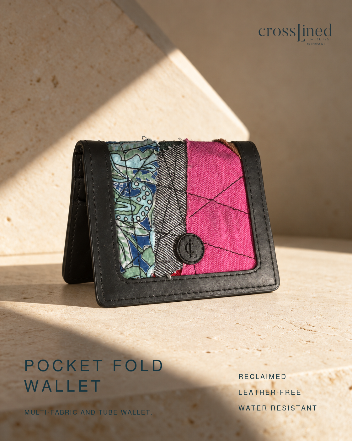 A crosslined Pocket Fold Wallet made from reclaimed fabrics, featuring a black tyre tube trim and a front panel with a green patterned section, a gray woven section, and a bright pink quilted section. The wallet is displayed on a textured stone surface with dramatic diagonal lighting.