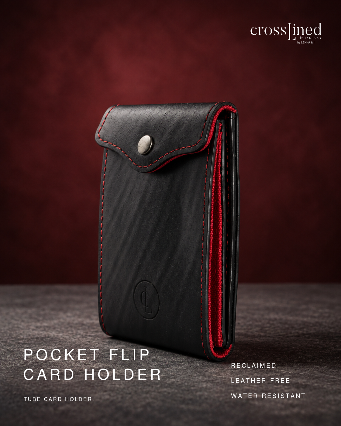 A black leather-free tube card holder with red stitching and a silver snap closure, shown standing upright on a dark textured surface against a dark red-brown gradient background. White text on the image reads 'crosslined by christopher' and 'POCKET FLIP CARD HOLDER', with additional product feature text on the right.