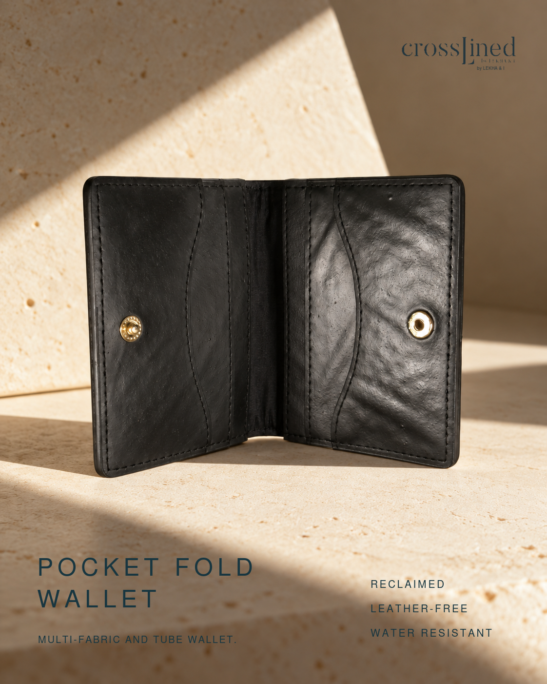 A black pocket fold wallet shown open, photographed on a warm beige stone surface with dramatic sunlight and shadows. The wallet has stitched card slots and snap closures on both sides.