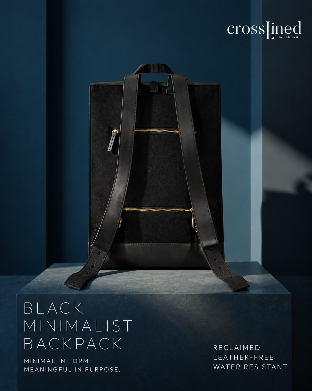 A black minimalist backpack with long shoulder straps and gold-tone zipper accents, displayed on a pedestal against a dark blue studio background. The Crosslined logo appears in the top right, and text at the bottom reads 'BLACK MINIMALIST BACKPACK' with additional product copy.