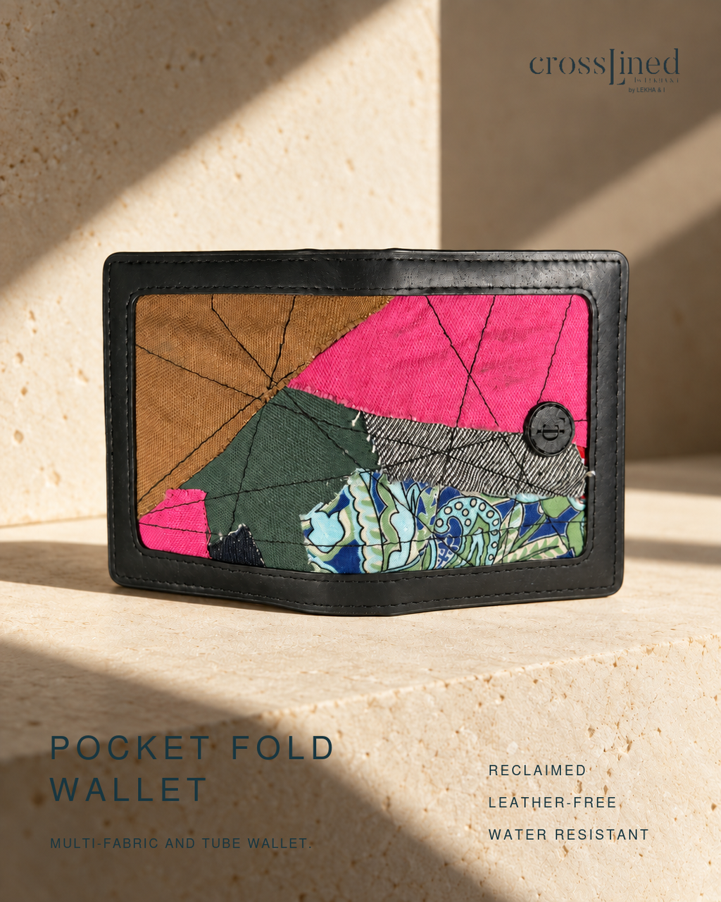A folded cardholder wallet with a black tyre tube border and a colorful geometric patchwork design, displayed on a textured stone surface with dramatic shadows. The brand name 'crosslined' is visible in the top right corner.