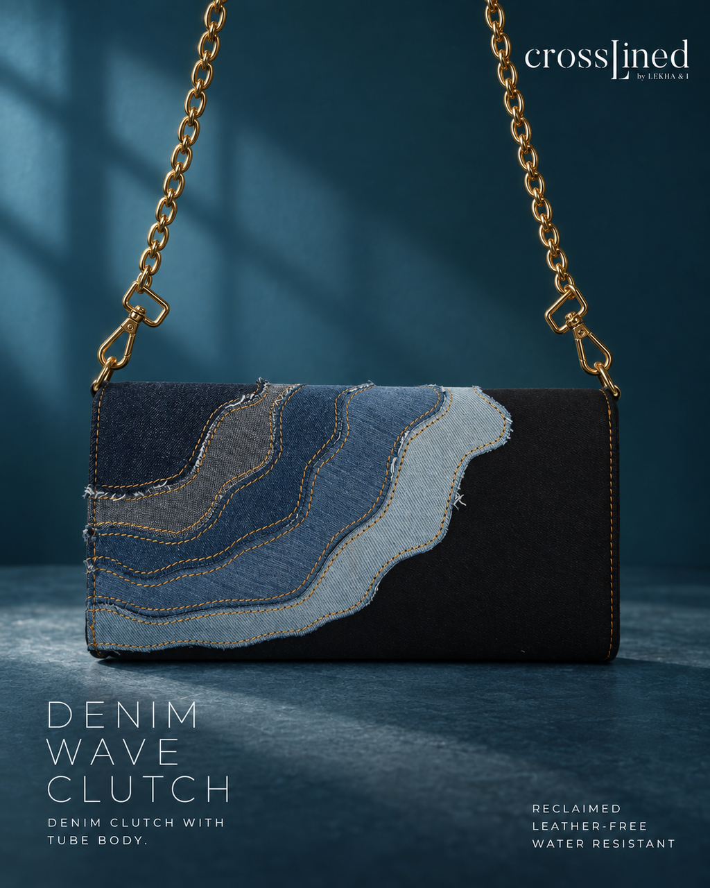 A Crosslined denim clutch bag with a wavy layered denim pattern in shades of blue and gray on a black base, featuring a gold chain strap, set against a dark blue background with soft window shadow overlays.