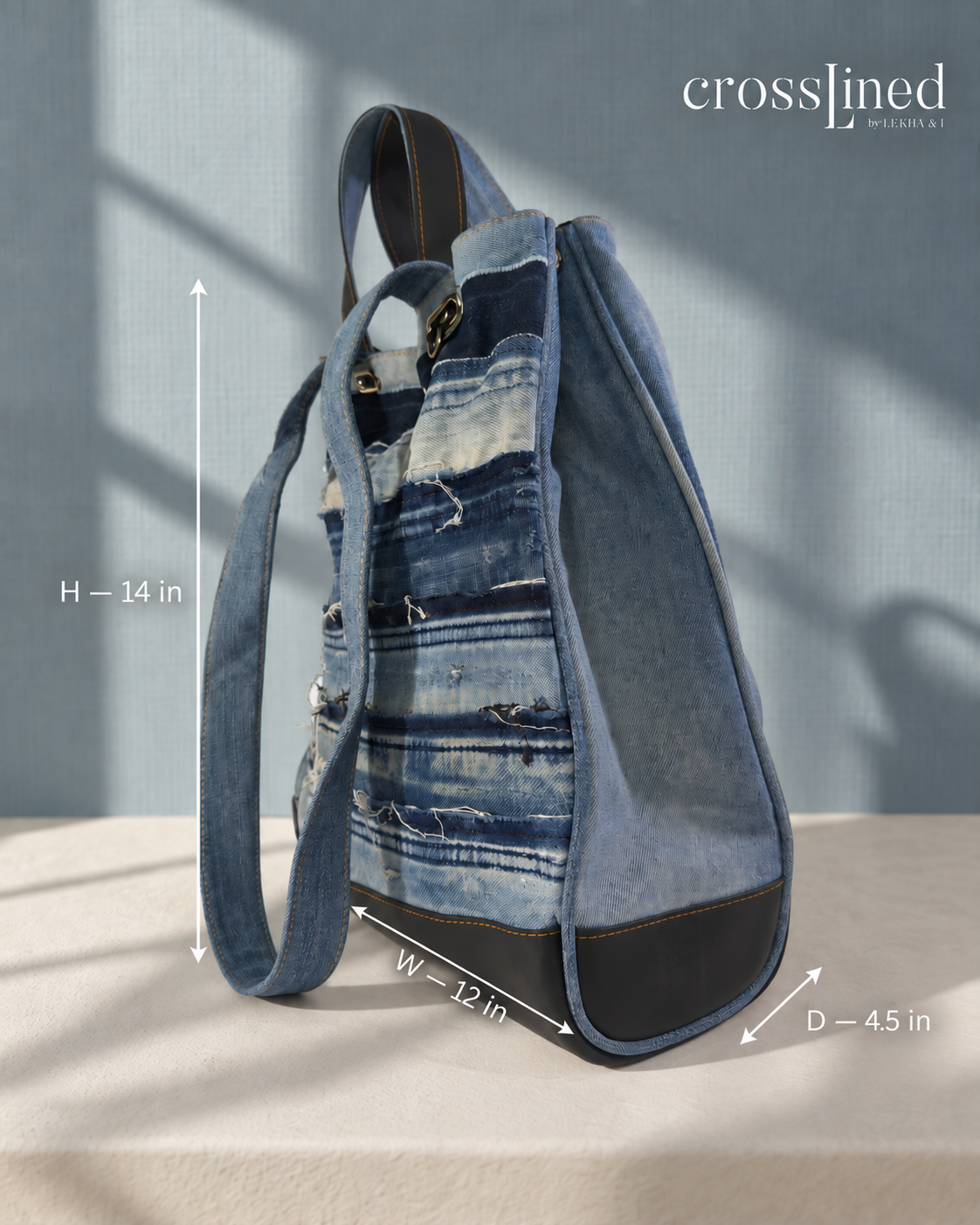 A denim tote bag with layered distressed blue denim panels shown with dimension lines indicating height, width, and depth. The brand name 'crosslined' is visible in the top right corner.