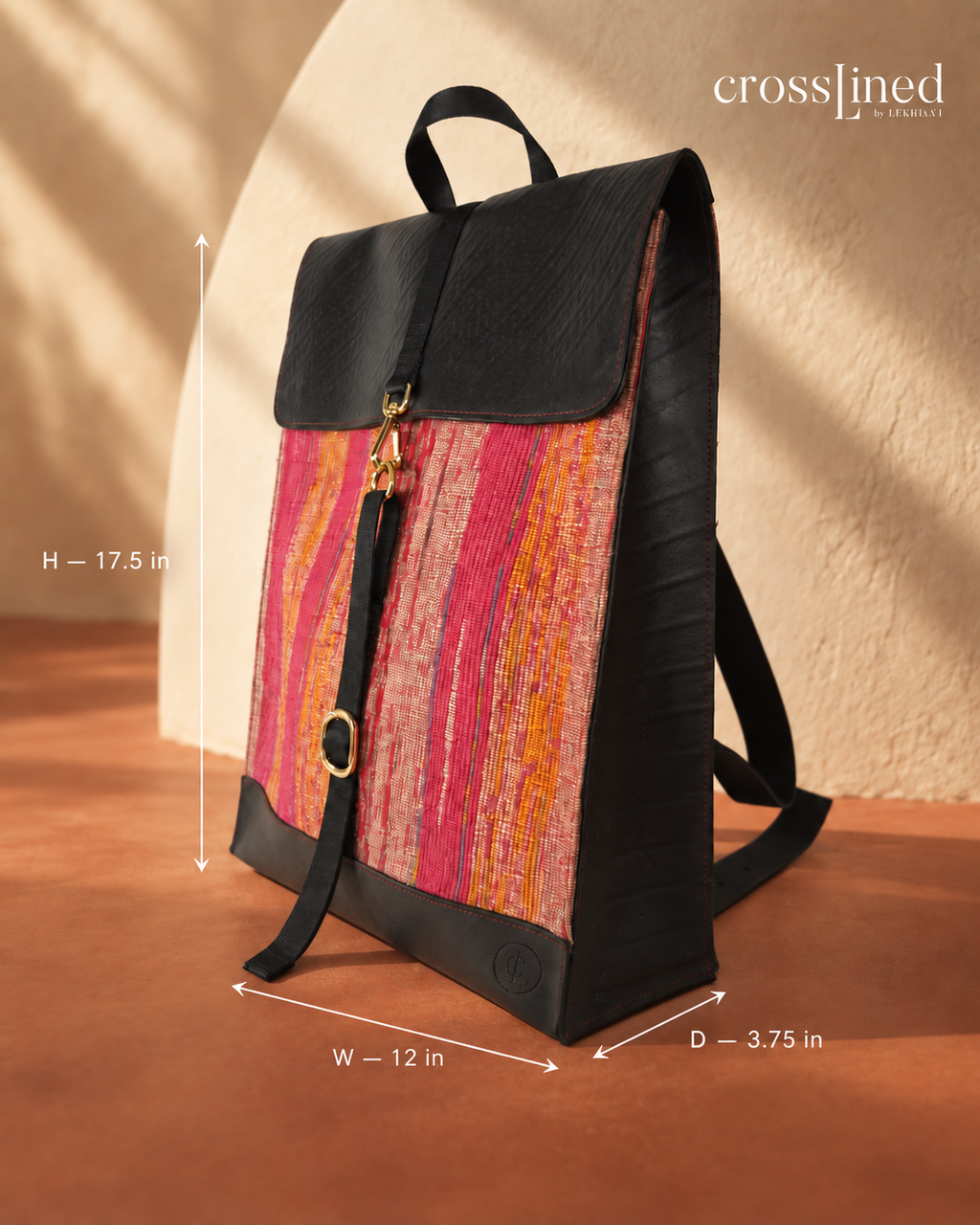 A Crosslined backpack with a black tyre tube top and base, and a vibrant pink, orange, and red patterned front panel, shown with dimension lines indicating its height, width, and depth.